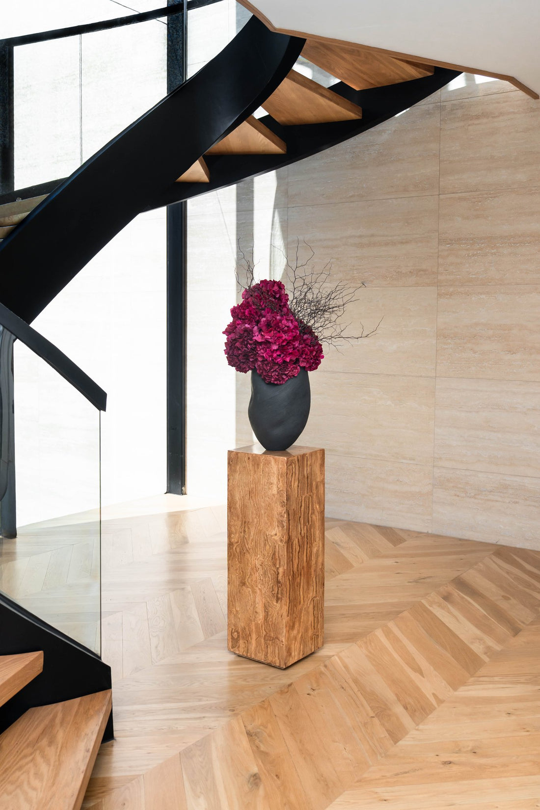 NATALIA burgundy hydrangea and corokia in Morph vase ebony styled by a staircase